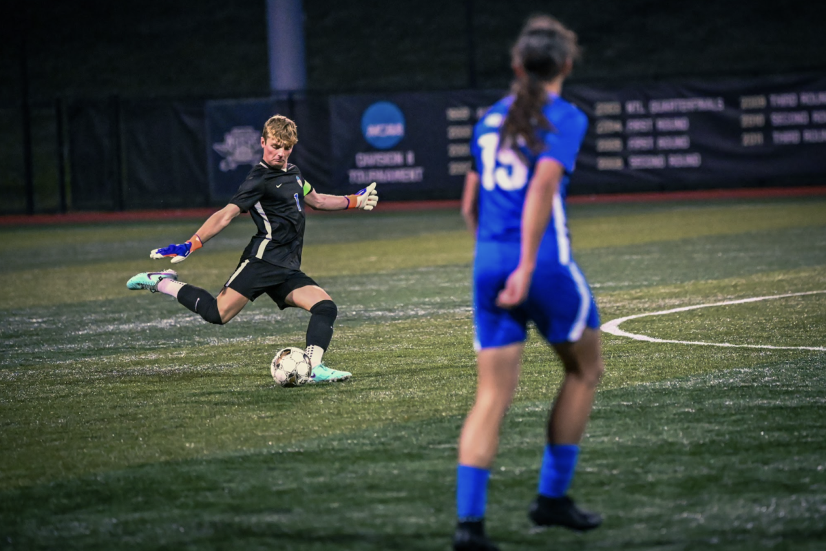 Sam Lang (12) kicks the ball.